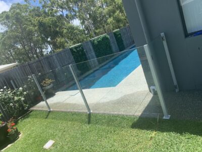 Semi-frameless glass pool fencing with powder coated posts